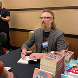 Kevin Maloney signing galley copies of The Red-Headed Pilgrim 