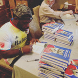 Author Hanif Abdurraqib signing copies of They Can't Kill Us Until They Kill Us